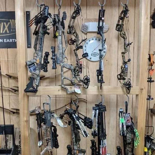 Assorted archery bows in a store display.