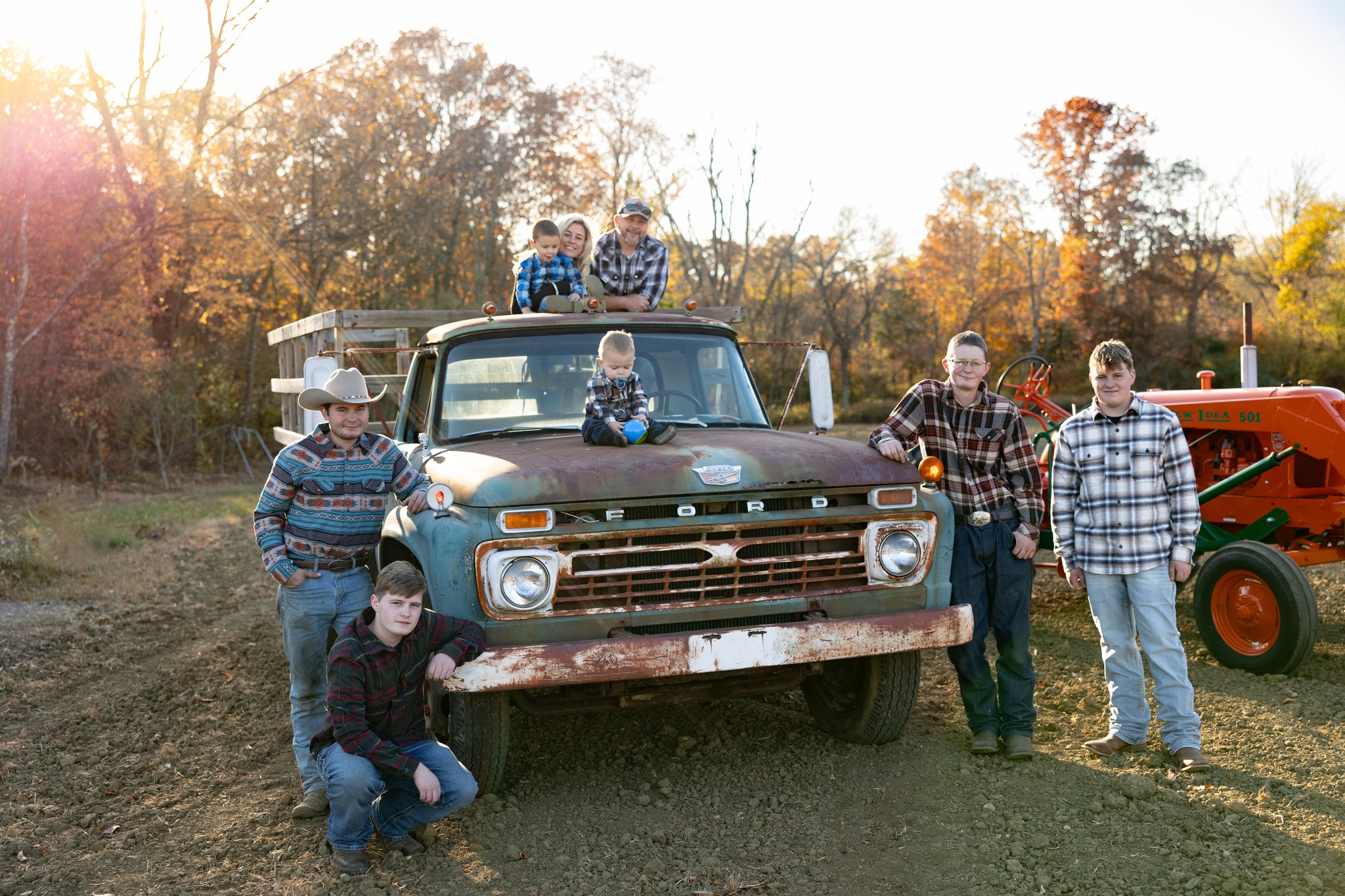 Family posing beside vintage Ford pickup