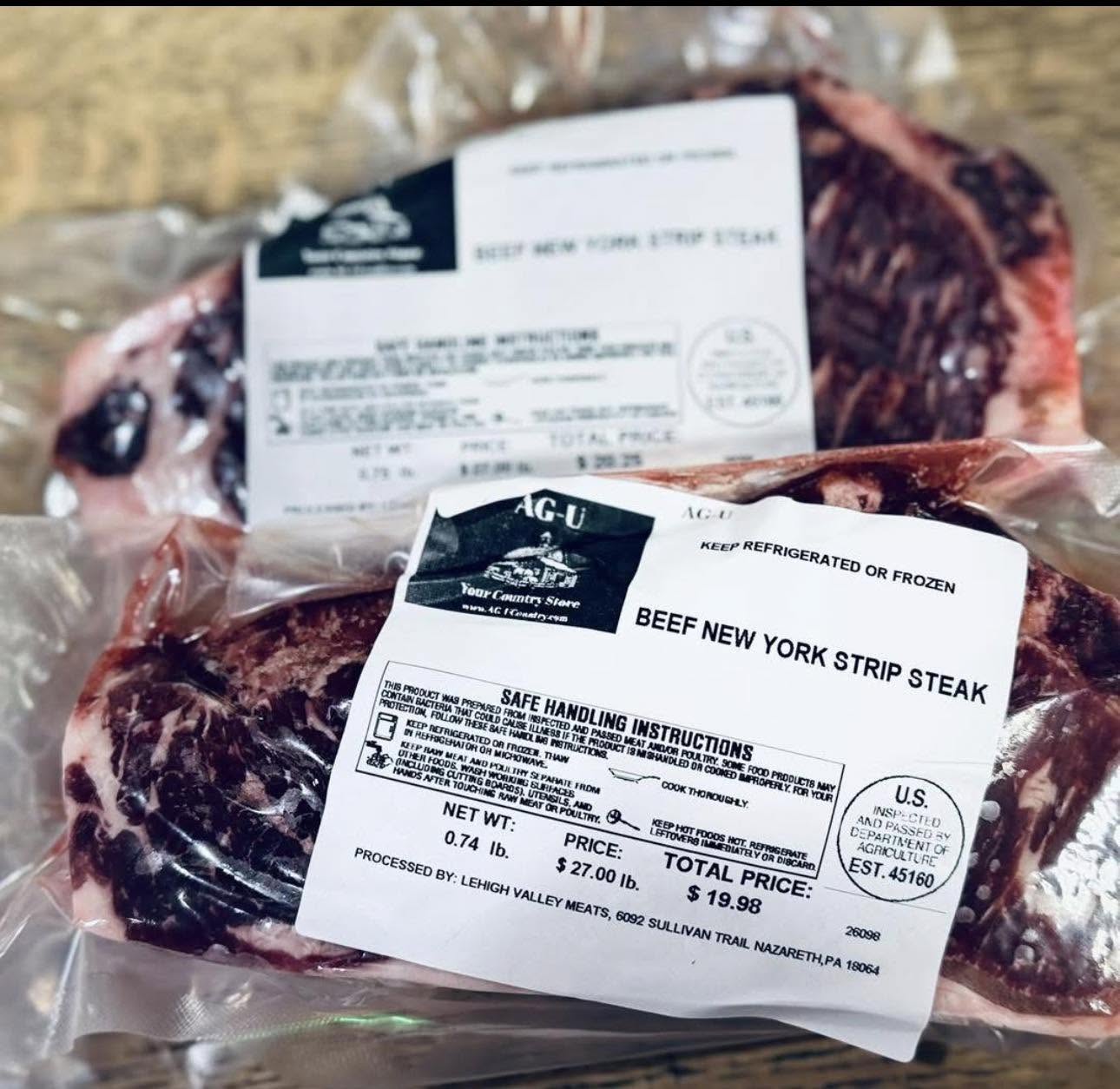 Vacuum-sealed beef New York strip steaks with labels