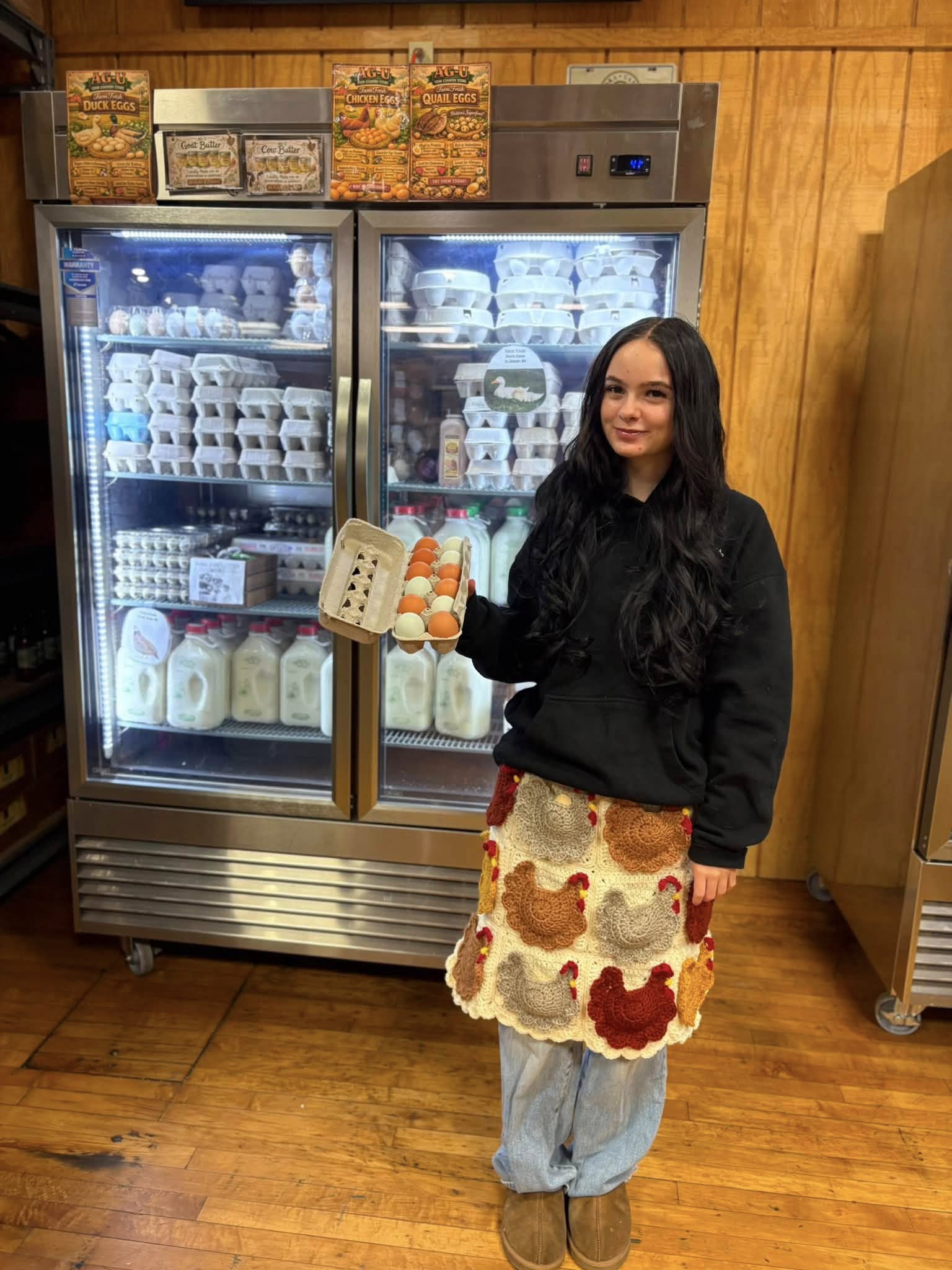Woman holding egg carton in grocery aisle