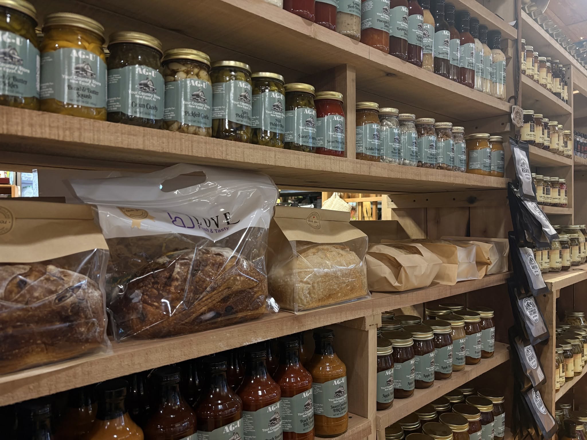 Glass jars and packaged bread on shelves